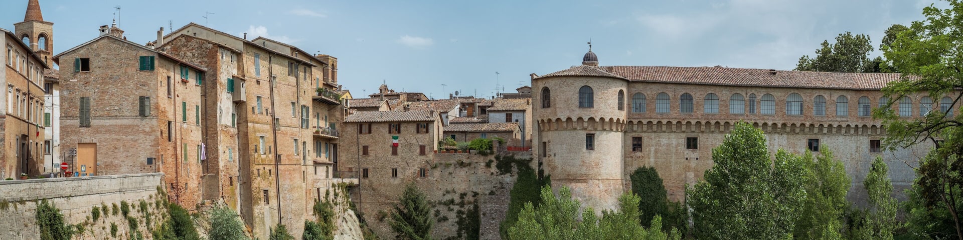 Houses and the Ducal Palace of Urbania overlooking the Metauro River, Pesaro and Urbino province, Marche, Italy.