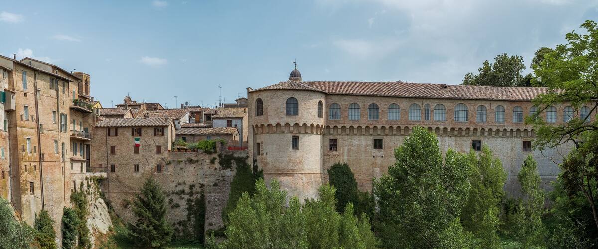 A historic town with stone buildings, a prominent church, and a castle-like structure.
