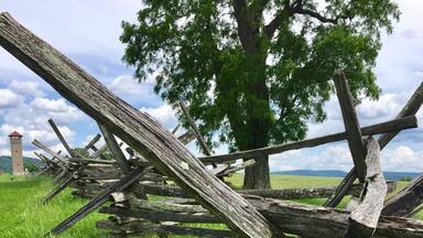 Looking through the fence line along the Sunken Road toward the observation tower that was built by Veterans in 1896.