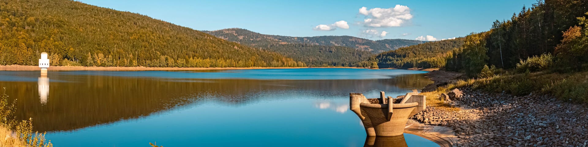 High resolution stitched panorama of a beautiful autumn or indian summer view with reflections at the famous drinking water reservoir Frauenau, Bavarian forest, Bavaria, Germany