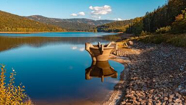 High resolution stitched panorama of a beautiful autumn or indian summer view with reflections at the famous drinking water reservoir Frauenau, Bavarian forest, Bavaria, Germany