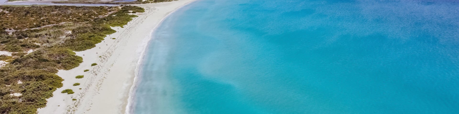 Aerial drone. Beautiful crystal clear water and sandy beach. Cittadella dei Maccari, San Lorenzo, Nature Reserve Oasis of Vendicari, Sicily near Noto.
