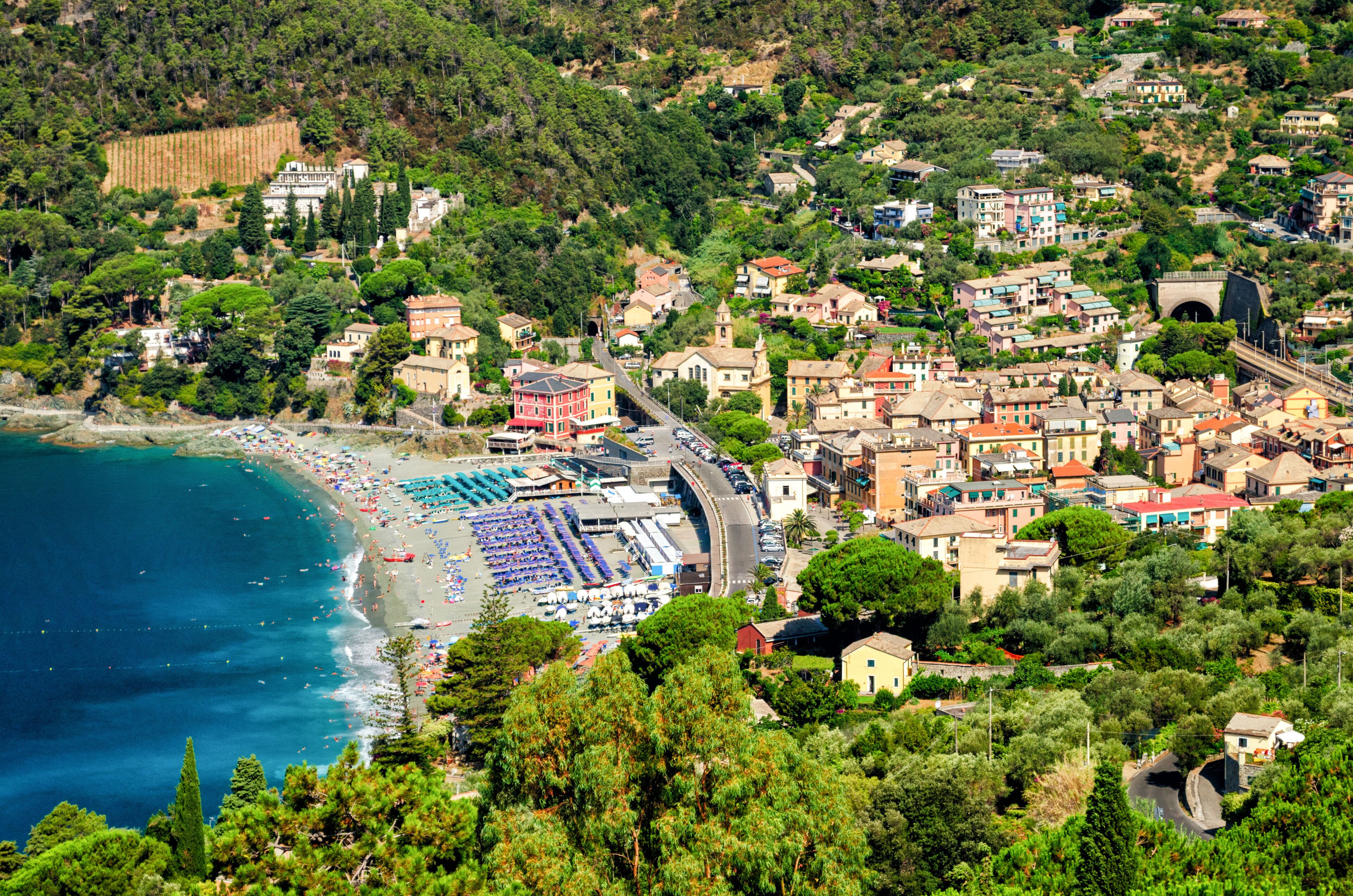 A coastal town with a beach, buildings, and a tunnel.