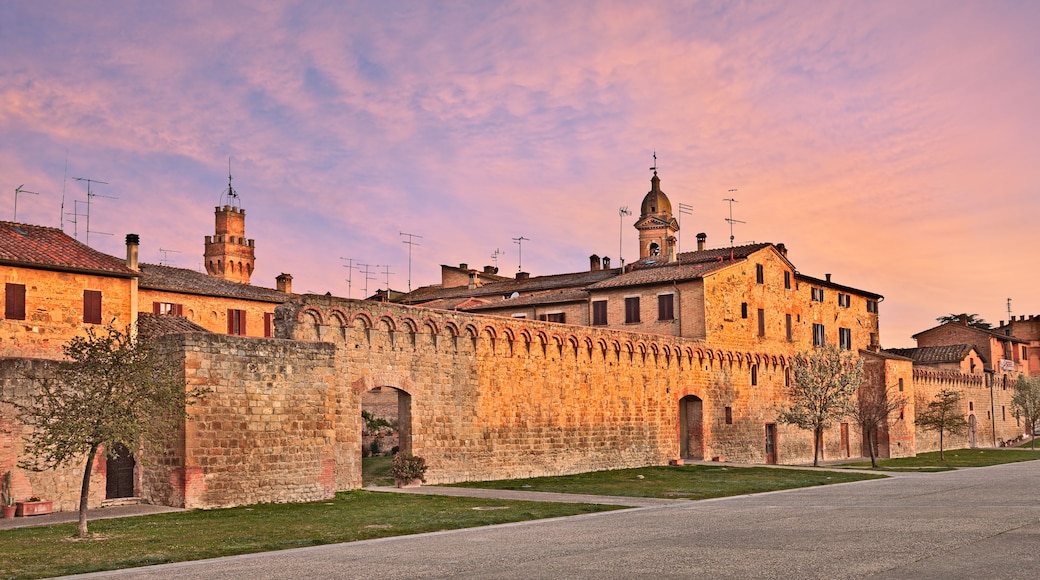 A historic stone building with arched walkways and a tower.