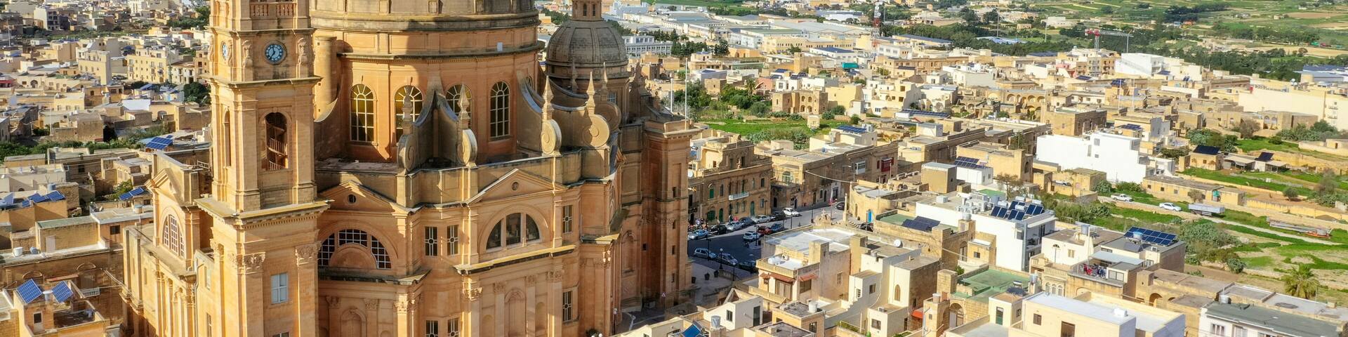 Aerial view oа St. John Baptist Church. Countryside of Gozo island, cloudy blue sky. Europe. Malta country