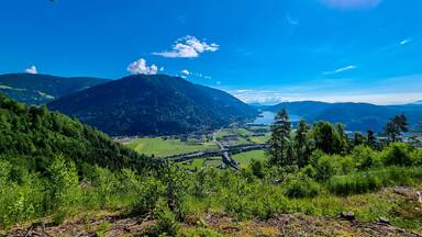 A panoramic view on the Karawanks in Carinhia, Austrian Alps. The mountains in the back are very steep and sharp. The view can be seen from Oswaldiberg, Villach. Clear and blue sky. Serenity
