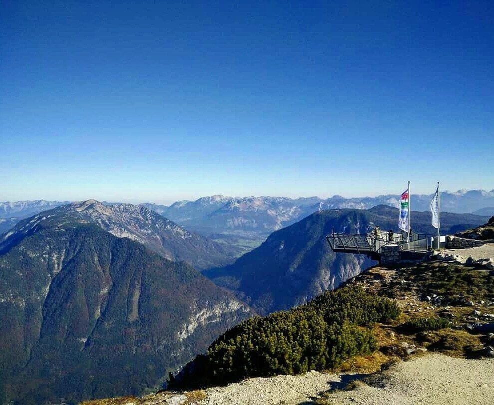 A mountain overlook with a viewing platform and flag.