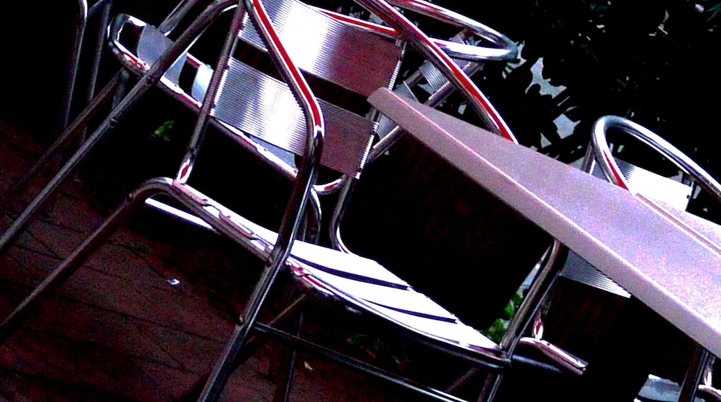 After searching for hours online with no luck whatsoever, I am reduced to providing only a description as a name. But this is a terrific place. A very informal order-at-the-counter "bar" that will serve you sandwiches and soup, grilled vegetables and salad, and a nice chunk of cake if you're up to it. I recommend it highly. You'll find it on the corner near the overpass of the Via Aurelia. Just remember "red umbrellas," and you can't go wrong.