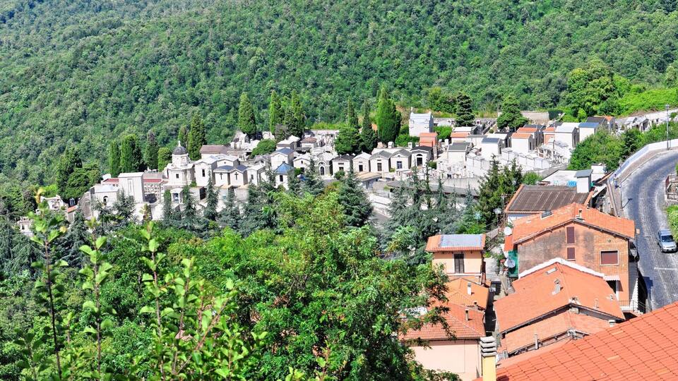 A hillside village with terraced houses and a church.