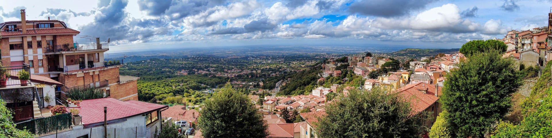 Overview from the panoramic terrace of Rocca di Papa a look towards countryside and Rome with a fantastic cloudy sky and dramatic light, Italy.