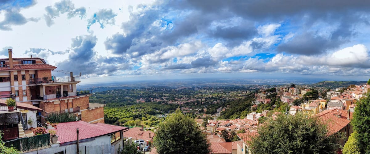 A mountainous town with terraced houses and a view of the valley below.