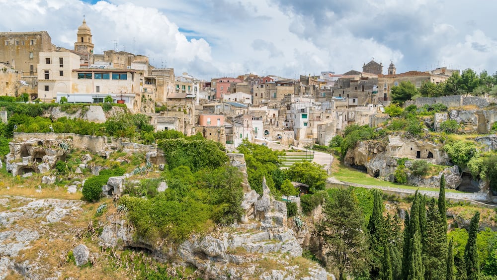 A historic town with ancient ruins and dense, multi-story buildings.