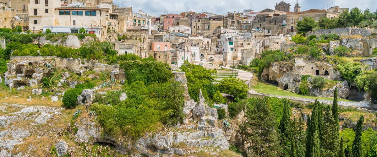 A historic town with ancient ruins and dense, multi-story buildings.