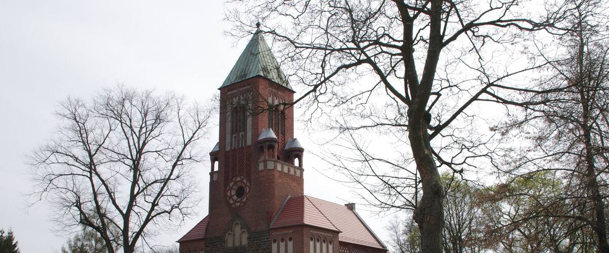 A historic church with a tall tower and a brick facade.