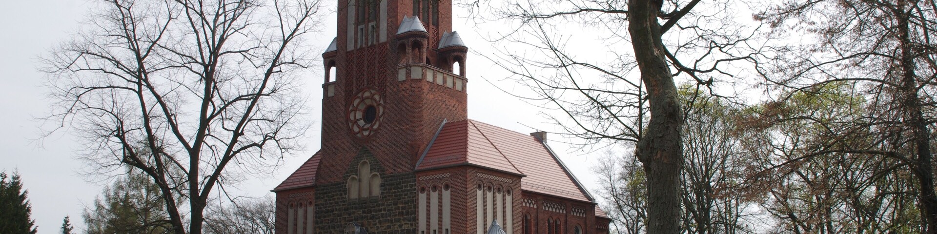 A historic church with a tall tower and a brick facade.