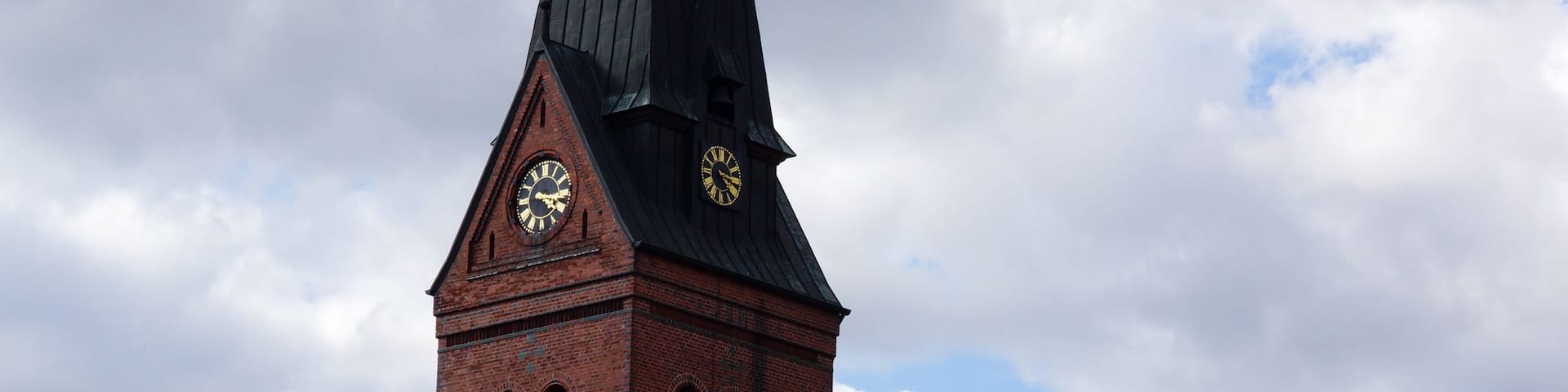 A church with a tall steeple and a clock.