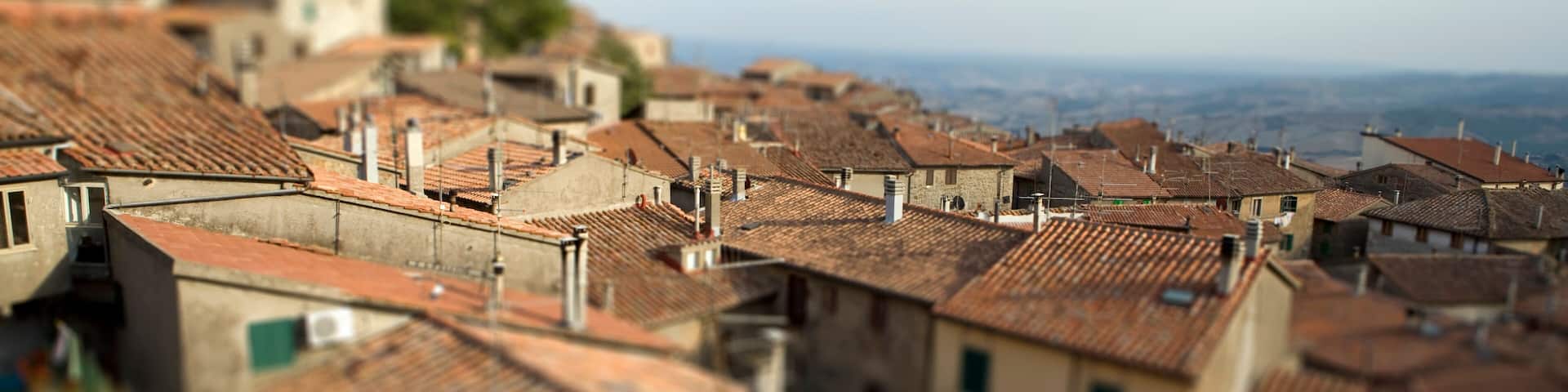 Tilt-shift - View of rootops of Piancastagnaio with countryside - Italy