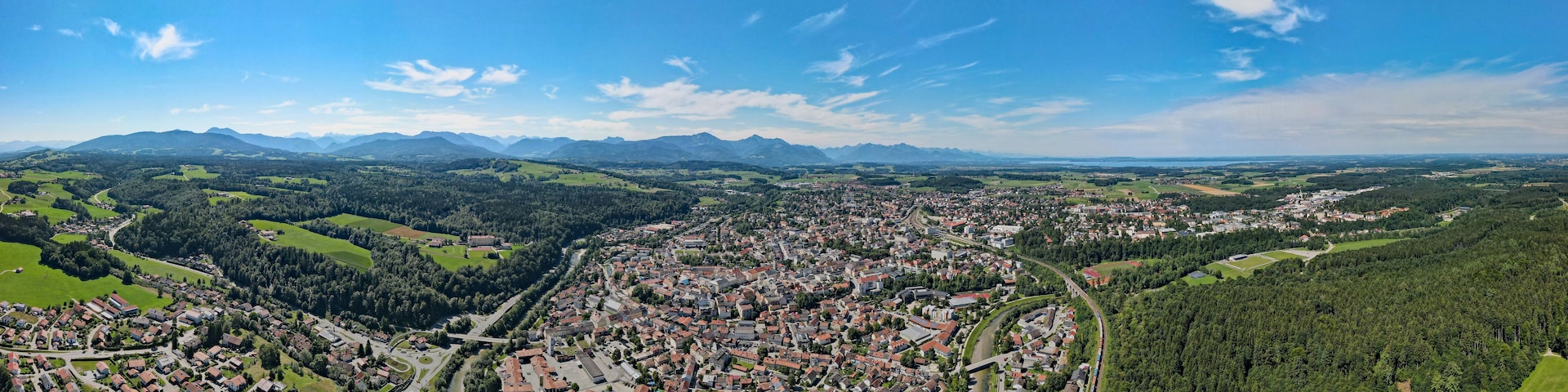 Vista panorámica de un pueblo enclavado en un valle, con montañas al fondo.