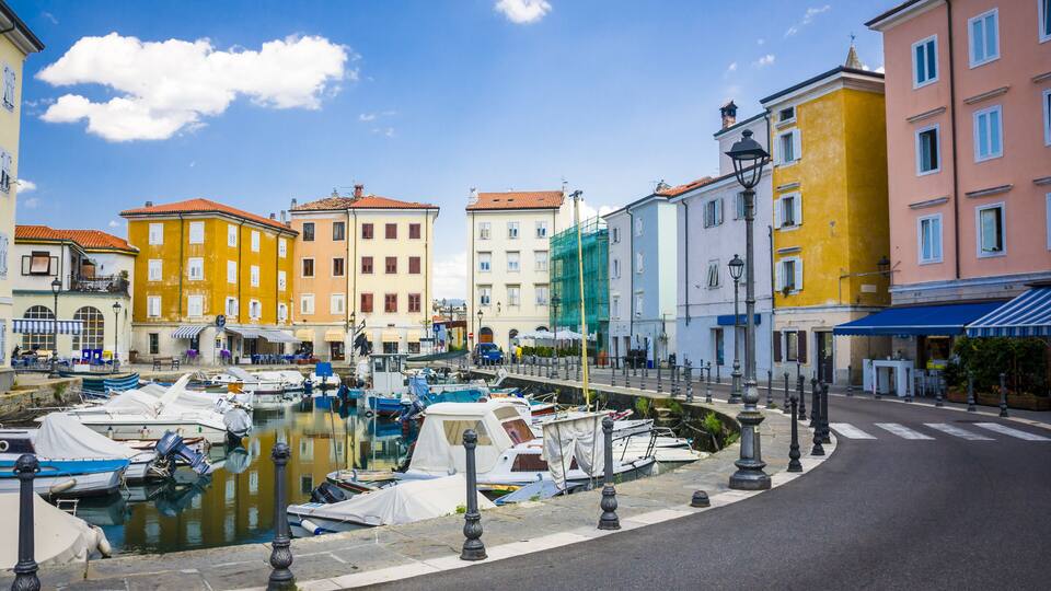 A marina with colorful buildings and boats docked.