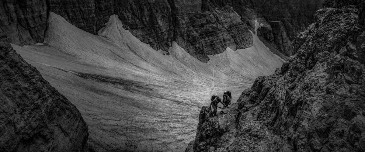A rugged mountainous landscape with steep cliffs and a narrow valley.