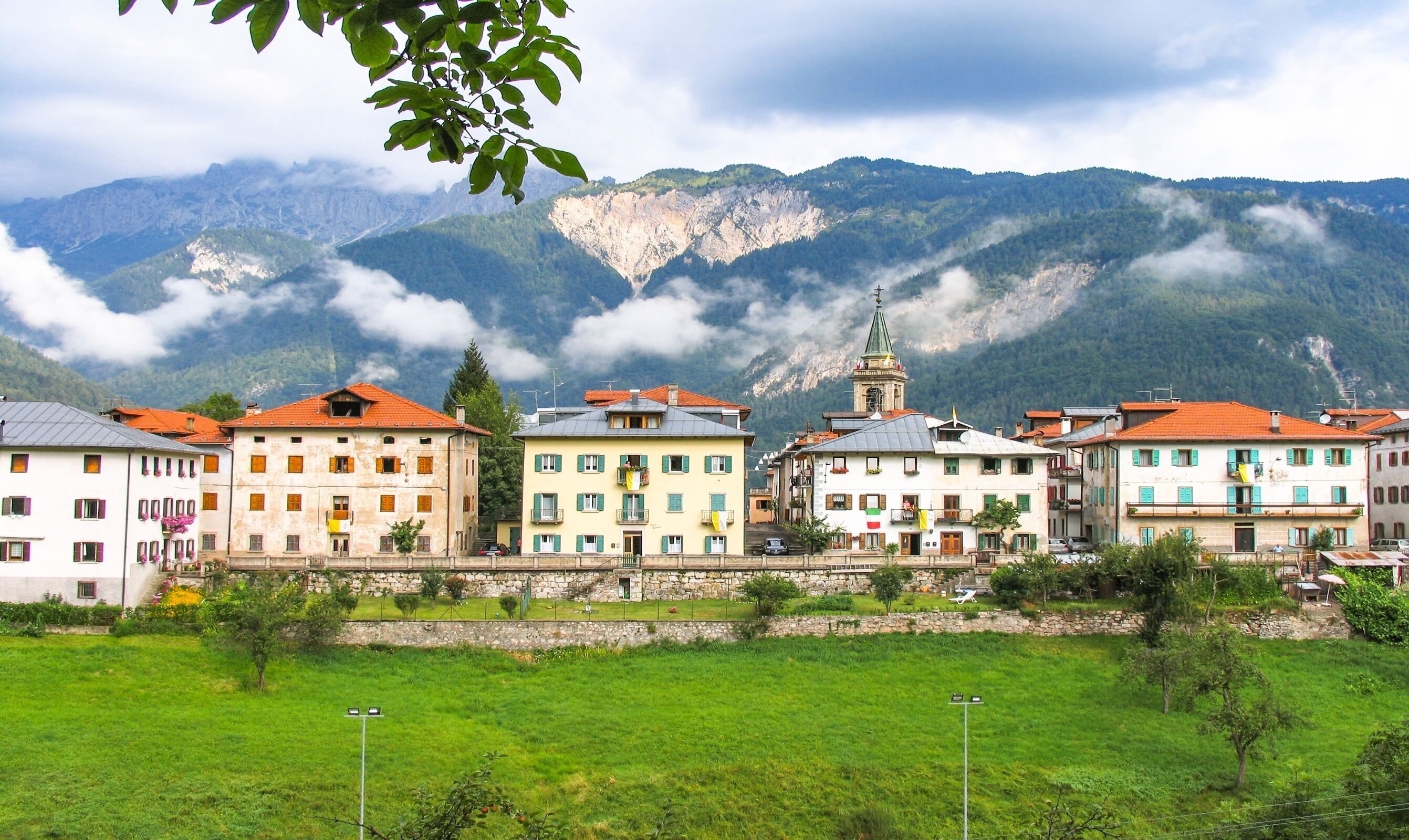 A town with colorful buildings and a mountain backdrop.
