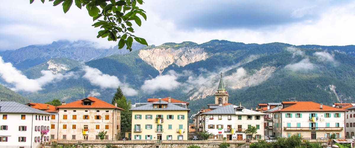 A town with colorful buildings and a mountain backdrop.
