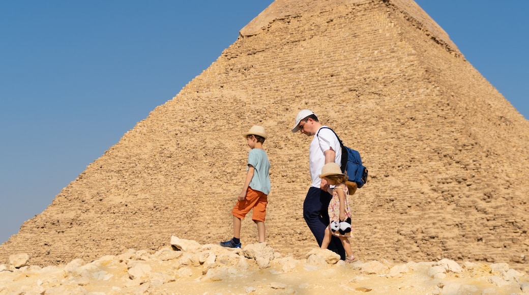Father and children walk in front of the Chephren pyramid on the Giza plateau