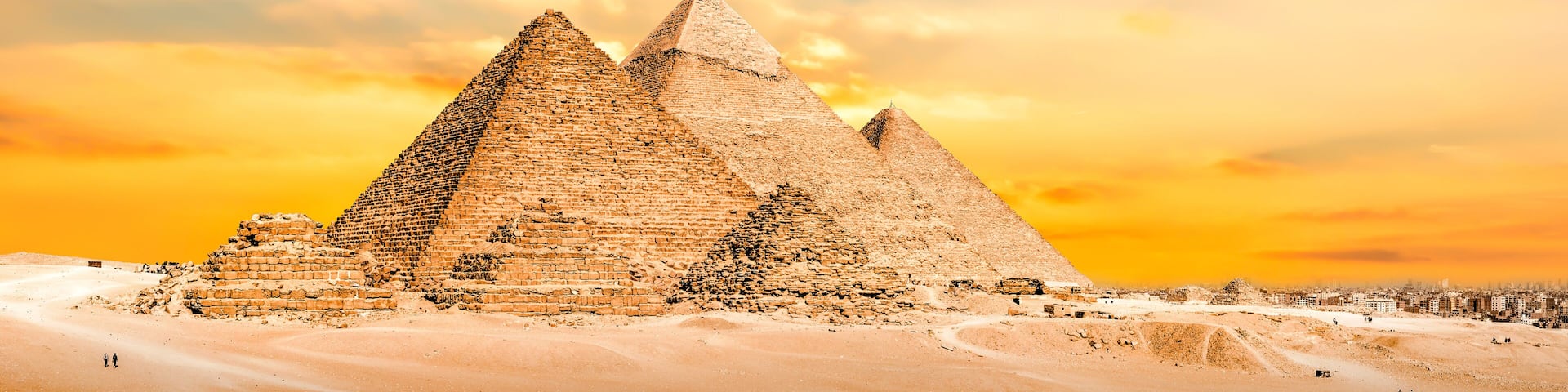 The Great Pyramid of Giza with the Sphinx in the background, set against a desert landscape.