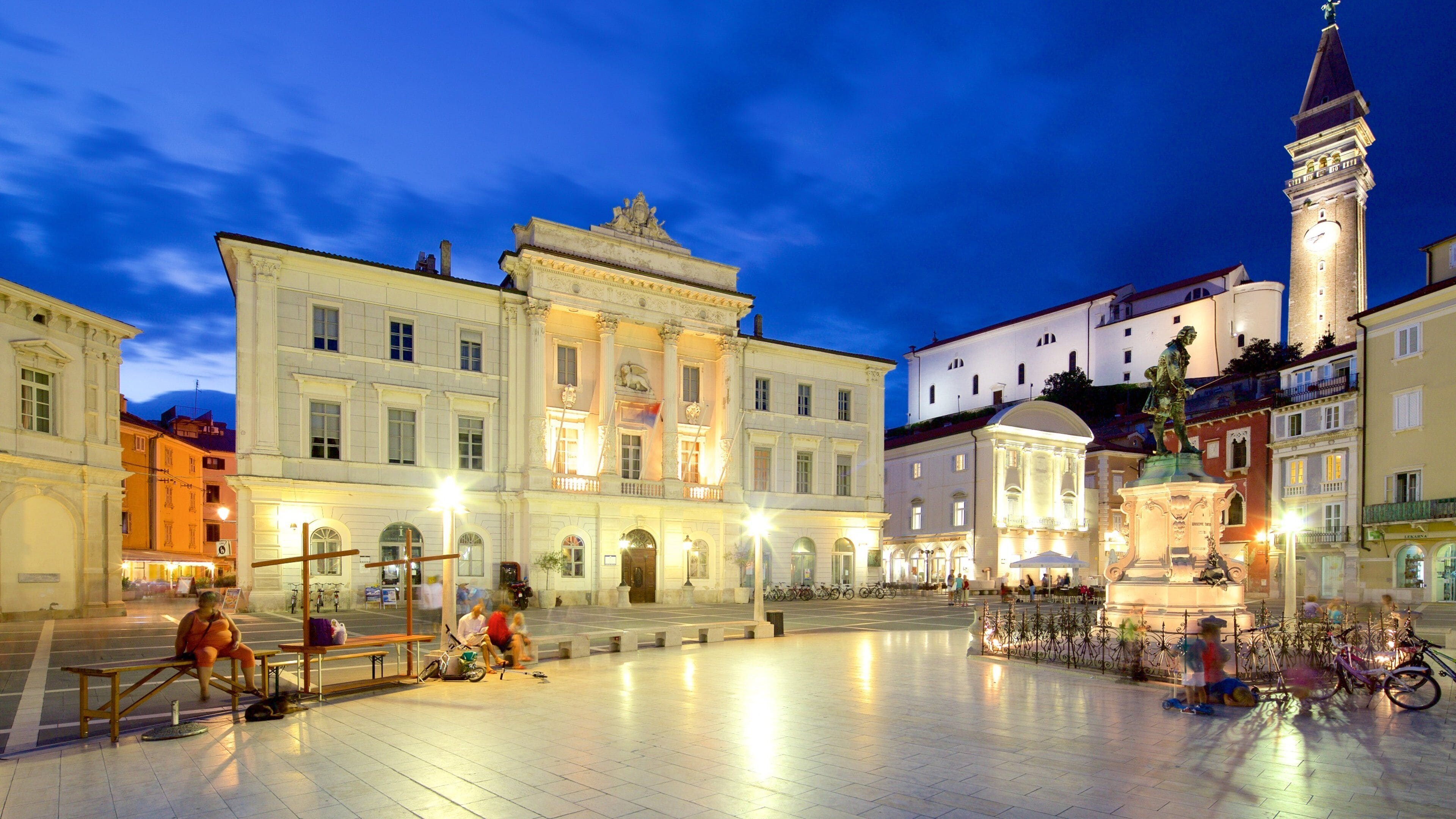 Piran which includes night scenes, a square or plaza and a statue or sculpture
