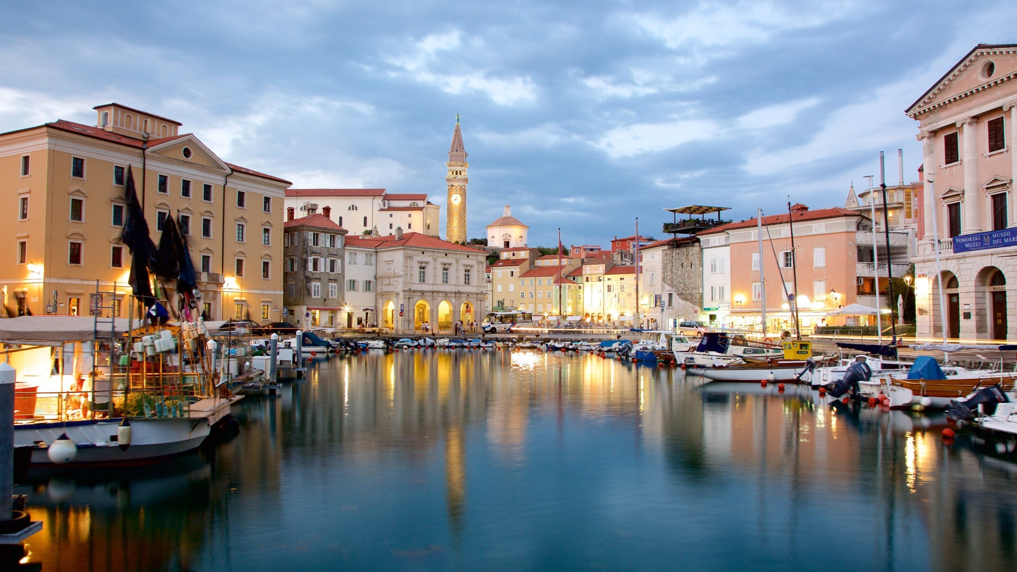 Piran which includes night scenes, a coastal town and boating