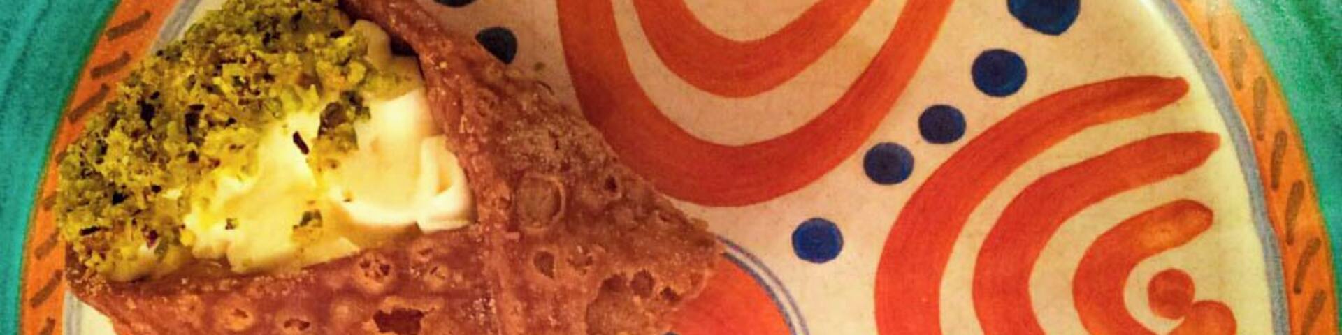 #Lunchtime
The Sicilian cannolo is one of the most famous Italian sweets in the world. Contrary to what most people believe, these delicious ricotta-cream filled wafers have been around for a long, long time. During his time spent in Sicily as a Roman queastor, Cicero fell in love with a predecessor of the modern cannolo. He described the dessert as a tube stuffed with a sweet, milk-based filling.
According to some accounts, however, the creation of modern cannoli came as a result of the Arabs who once controlled Sicily. This satisfying sweet was likely created inside a Muslim harem in the city of Kalt El Nissa, modern-day Caltanissetta. In this harem, the women spent their time preparing this delicacy.
In fact, it may very well have been on of these women who modified a preexisting Arab dessert made with ricotta, almonds and honey to fit Ciceroâs description. In doing so, she created what is now known throughout the world as Sicilian cannoli.