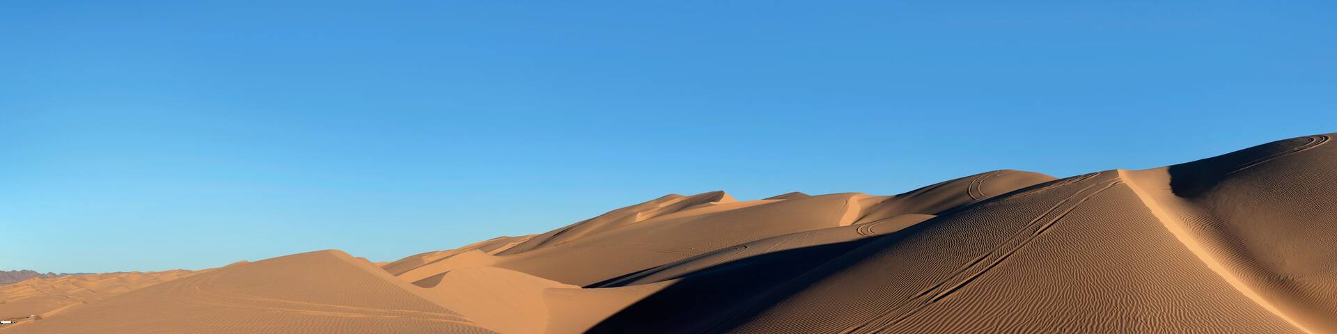 Horizontal panorama desert sand dunes and blue sky
