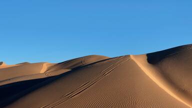 Horizontal panorama desert sand dunes and blue sky