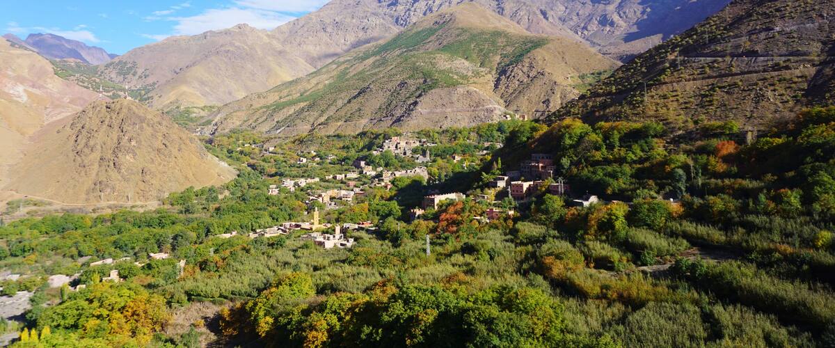 A mountainous landscape with a village nestled among the hills.