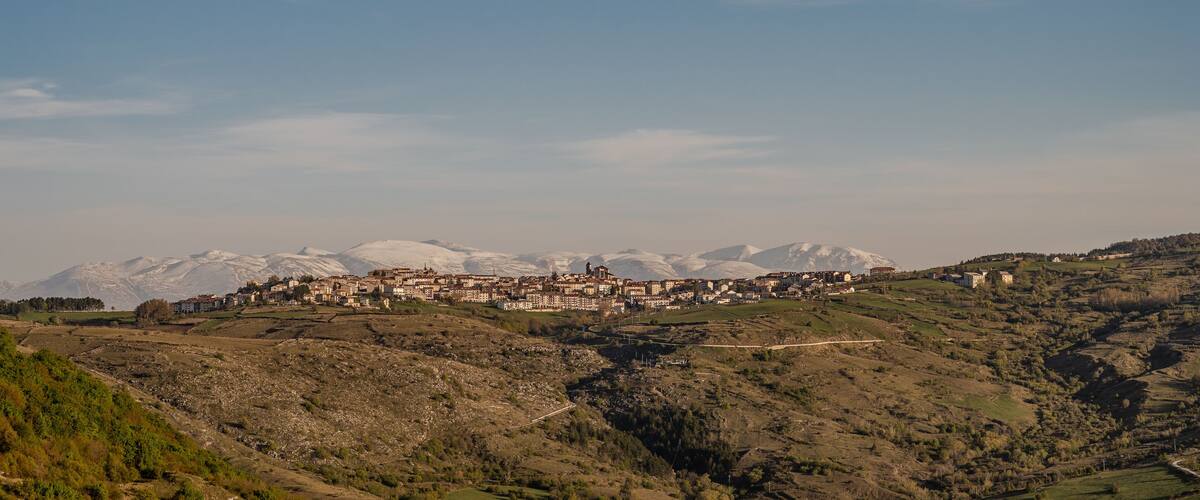 A mountainous landscape with a village nestled among the hills.