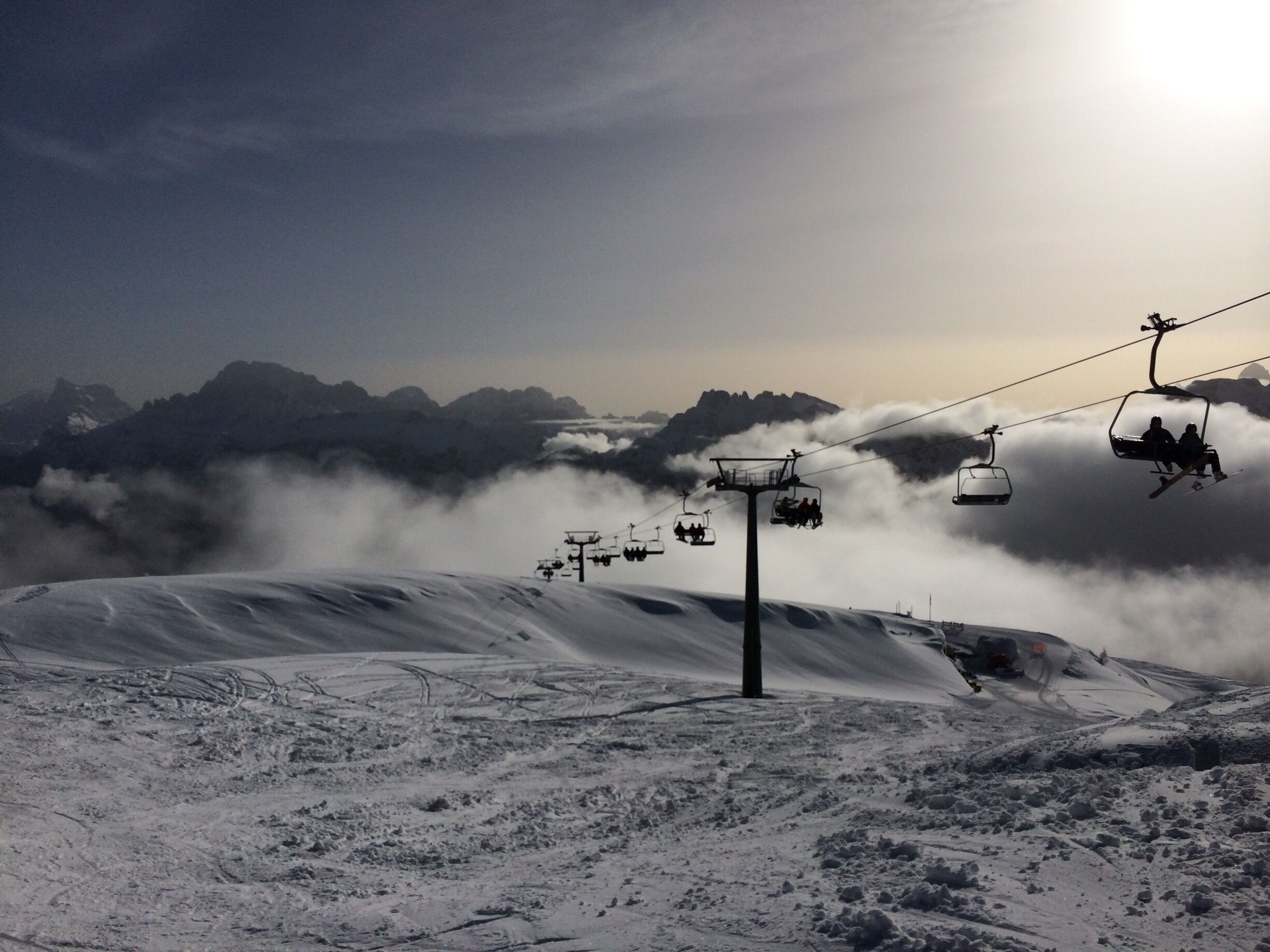 A snow-covered mountain with a ski lift and a cable car system.