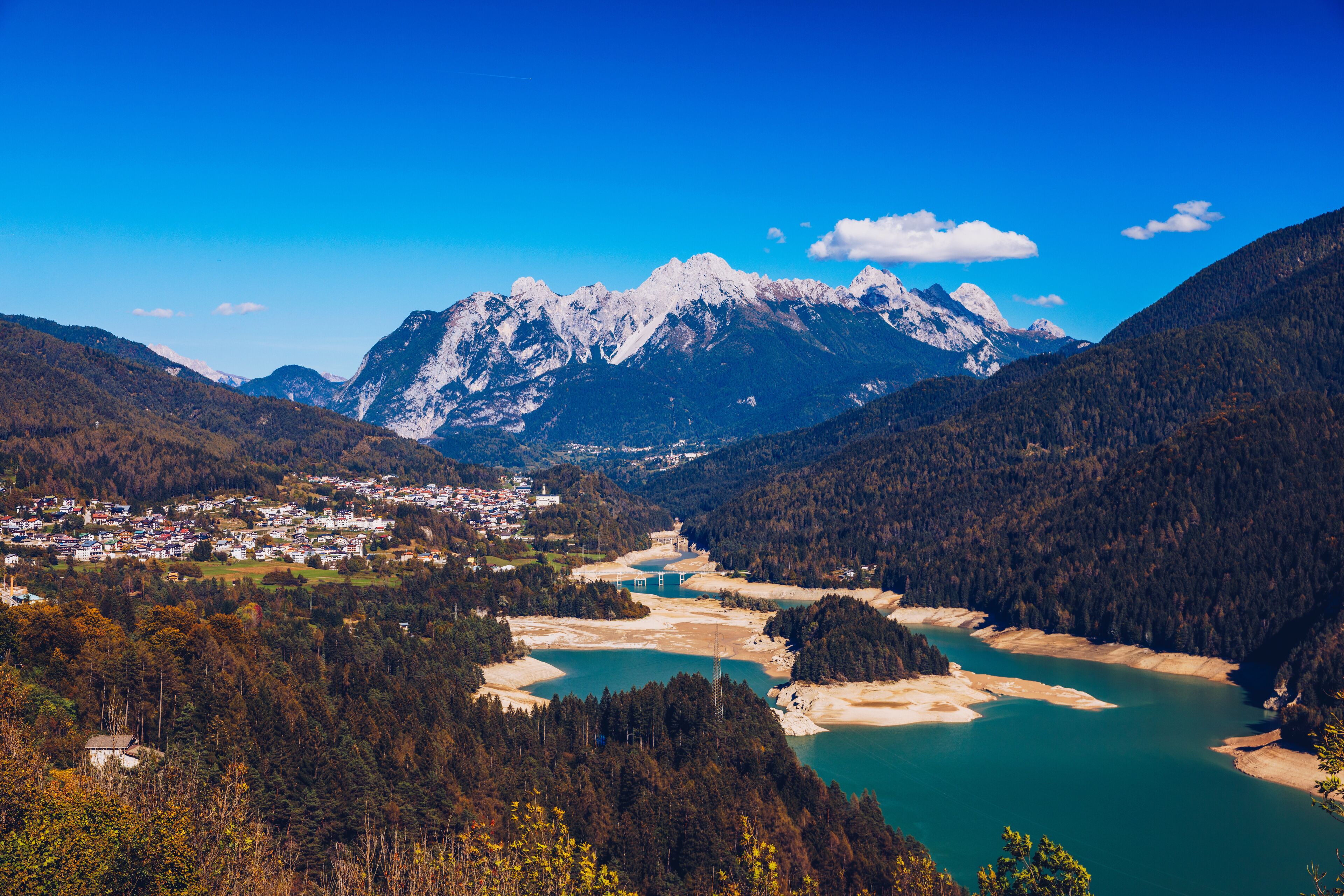 Panoramic view of lake of Centro Cadore in the Alps in Italy, Dolomites, near Belluno. View of Lake Calalzo, Belluno, Italy. Lake of Centro Cadore in the Alps in Italy, near Belluno.