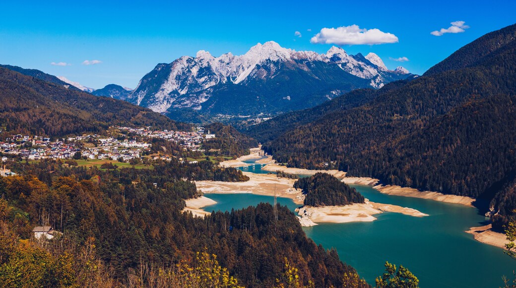Panoramic view of lake of Centro Cadore in the Alps in Italy, Dolomites, near Belluno. View of Lake Calalzo, Belluno, Italy. Lake of Centro Cadore in the Alps in Italy, near Belluno.