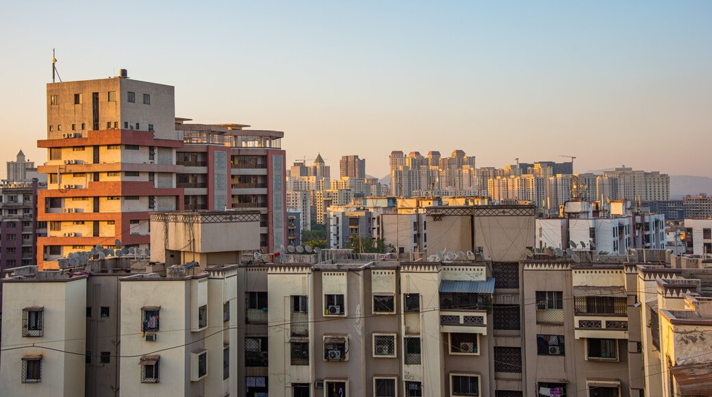Thane which includes a city and a sunset