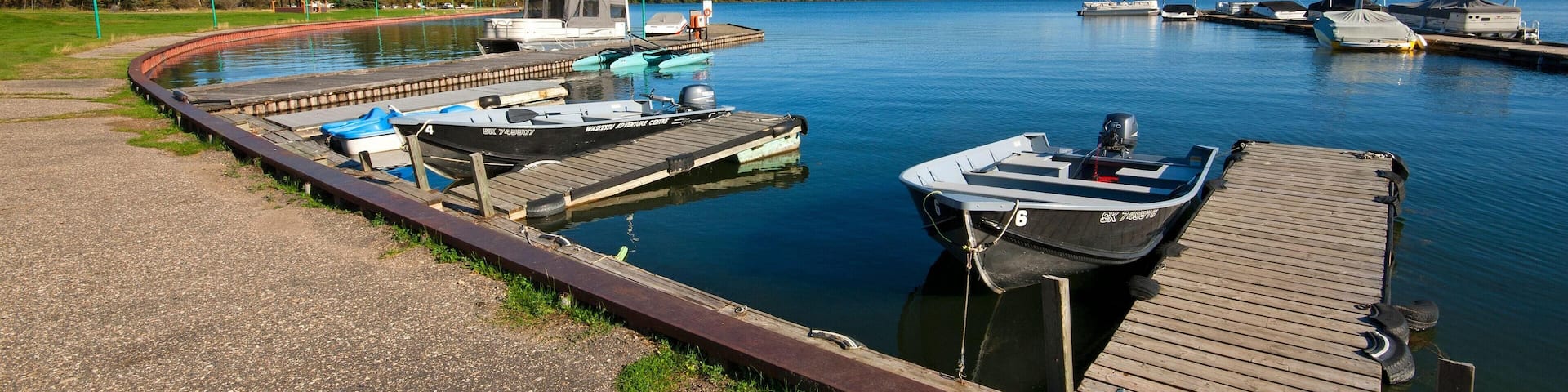 Boats moored at Waskesiu Lake shore, Prince Albert National Park, Saskatchewan, Canada