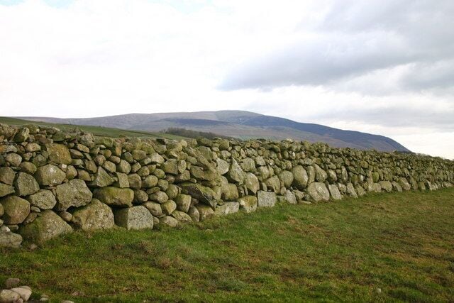 Big Stone Wall. Some of the lower stones in this wall are massive, having required great effort to move. Behind lies the bleak Corney Fell.