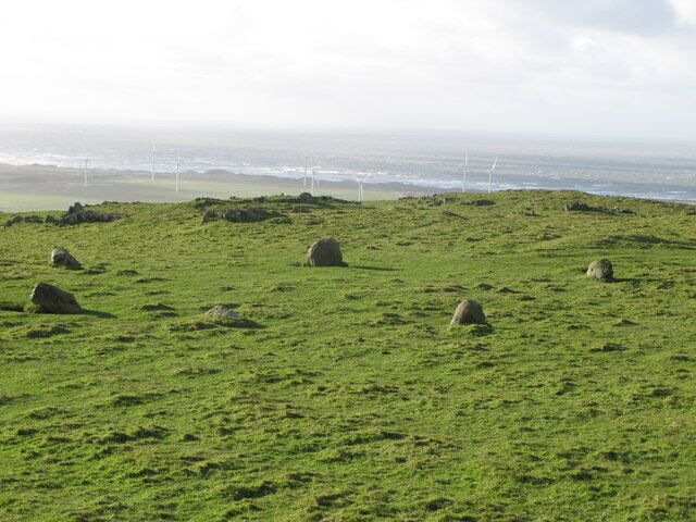 Stone Circle, Lacra This is a small circle on a plateau overlooking the Irish Sea. Haverigg wind farm is in the middle distance.