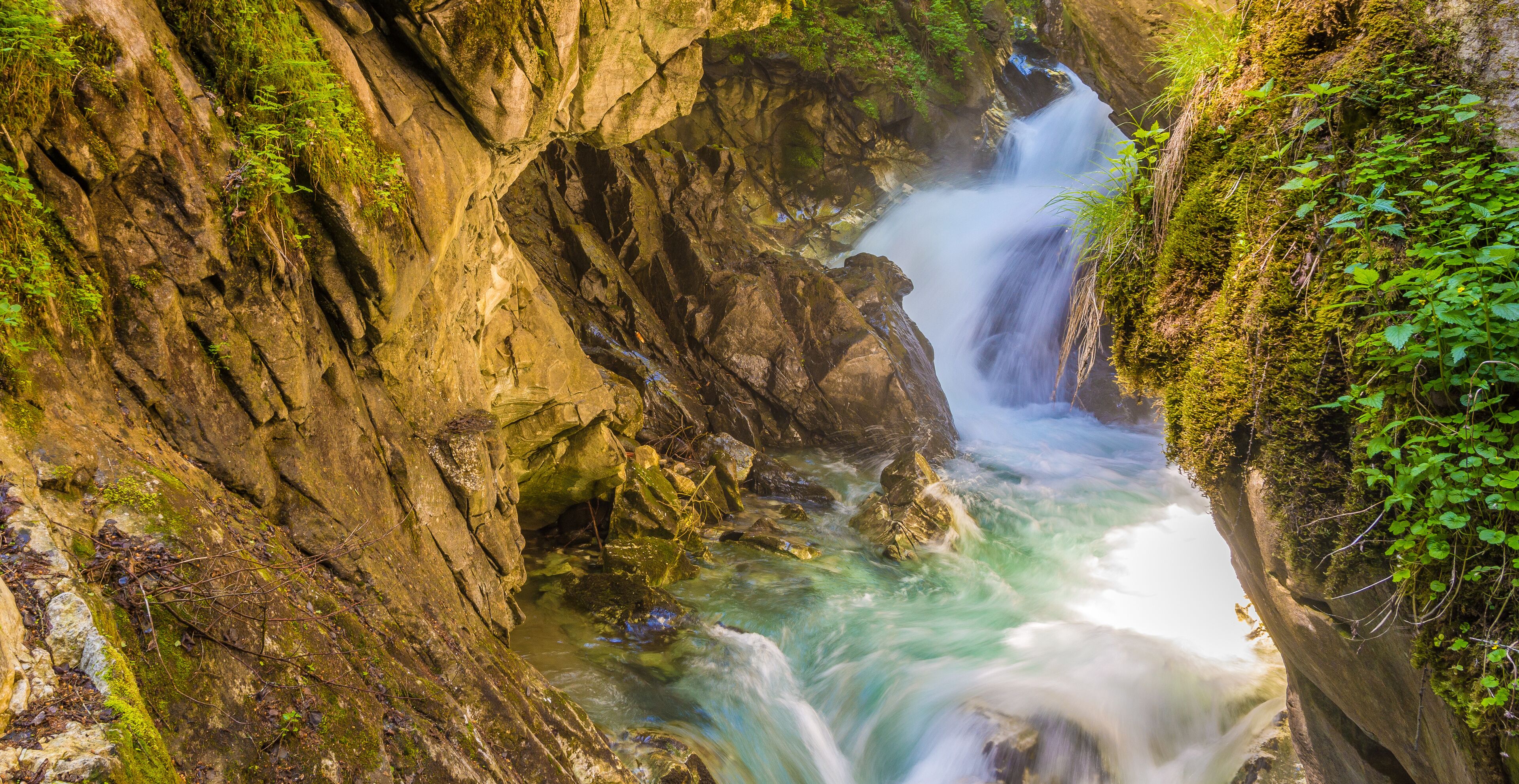 Waterfalls Stanghe (Gilfenklamm) localed near Racines, Bolzano in South Tyrol, Italy. Wooden bridges and runways lead through the canyon and give a spectacular sight to the waterfalls.