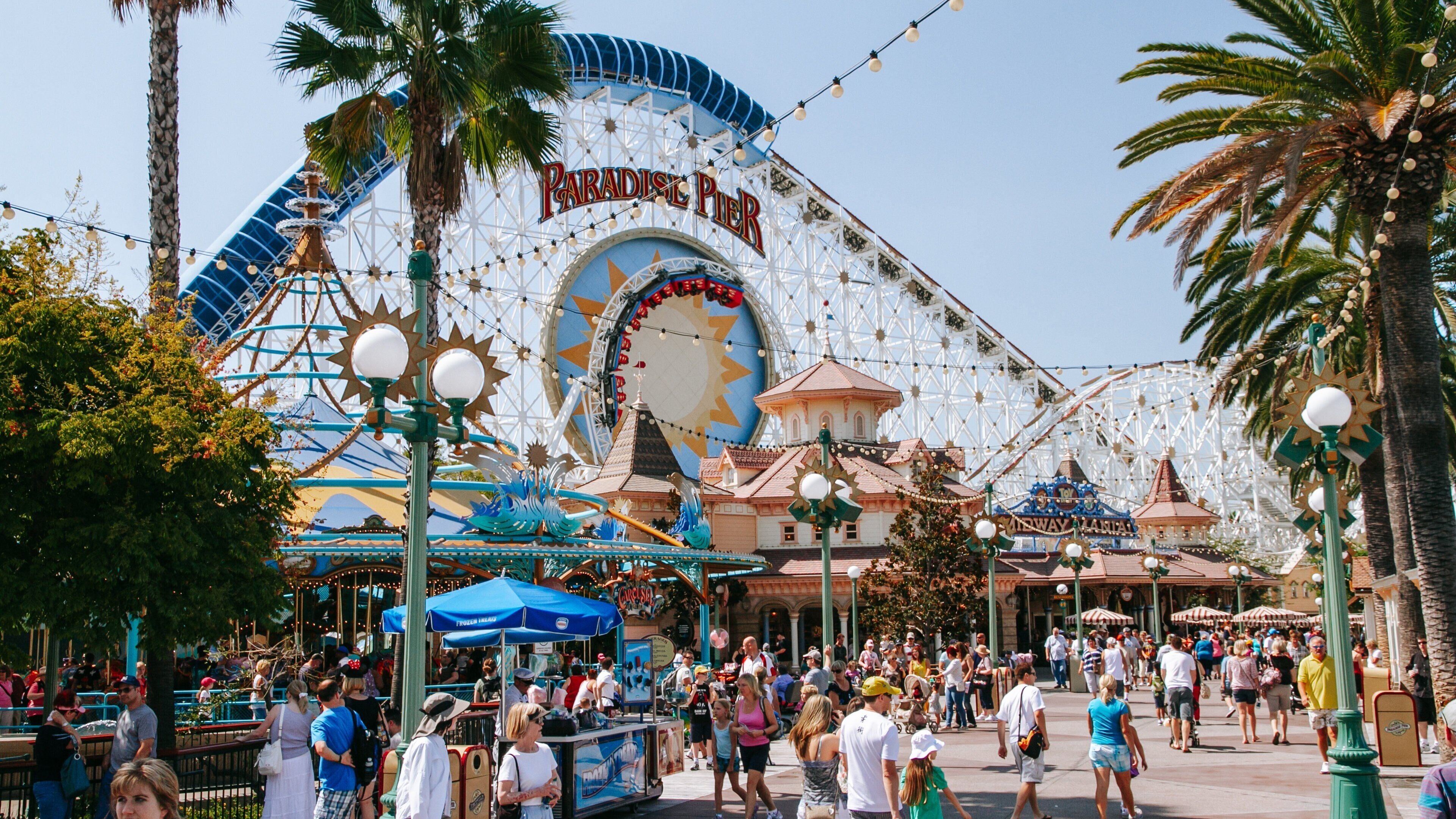 Disney California Adventure® Park showing rides as well as a large group of people