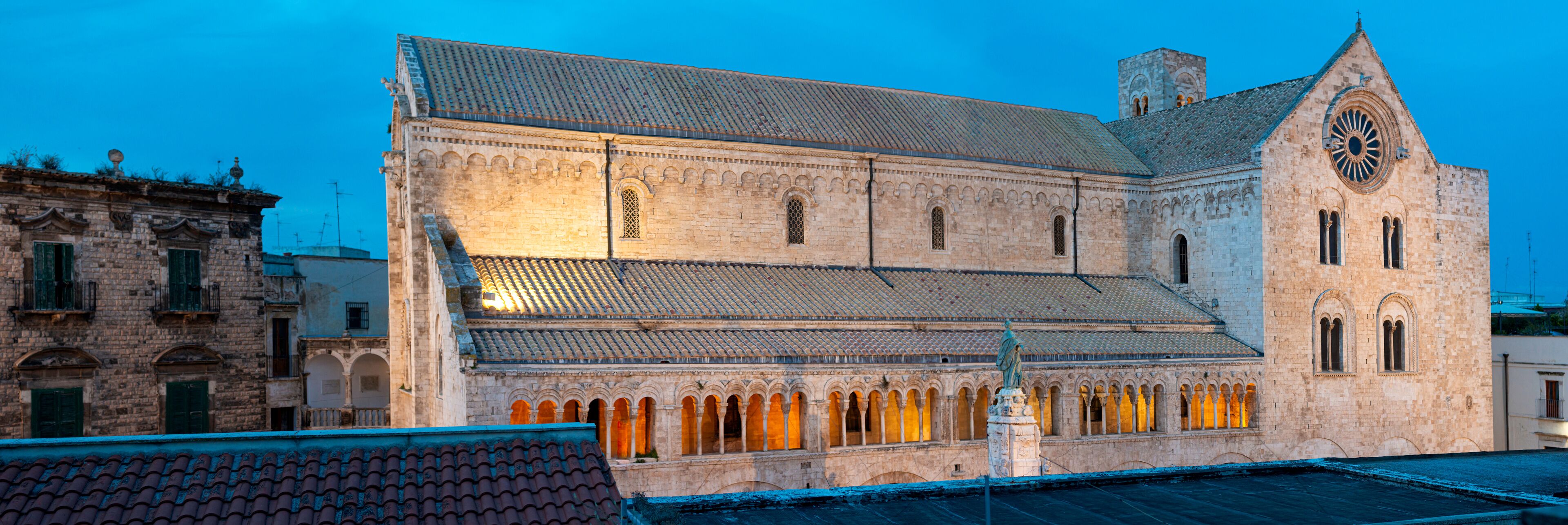 A historic building with a tiled roof and arched windows.