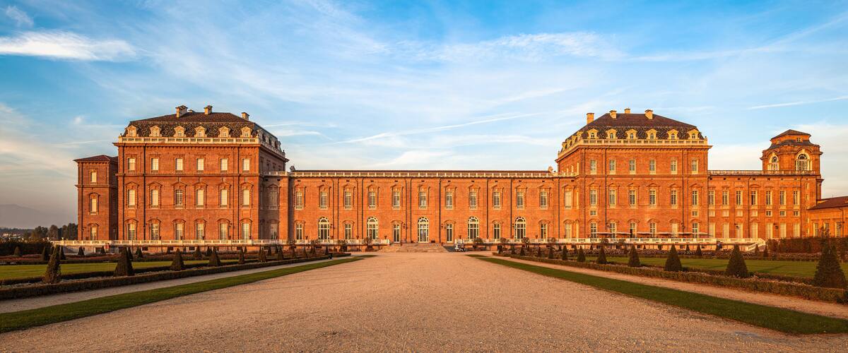 A large, symmetrical building with a central courtyard and symmetrical wings.