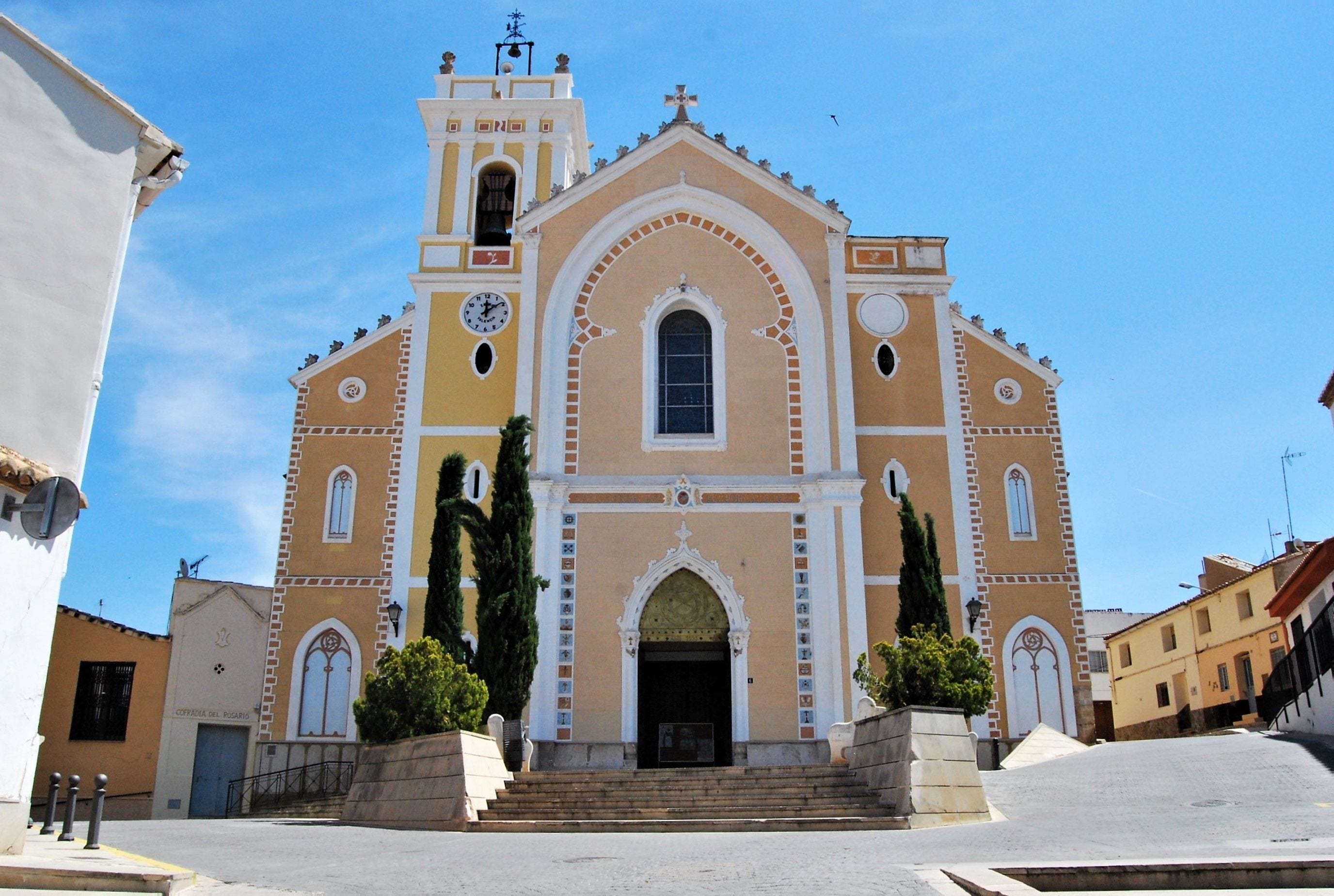 A church with a bell tower, arched windows, and a clock.