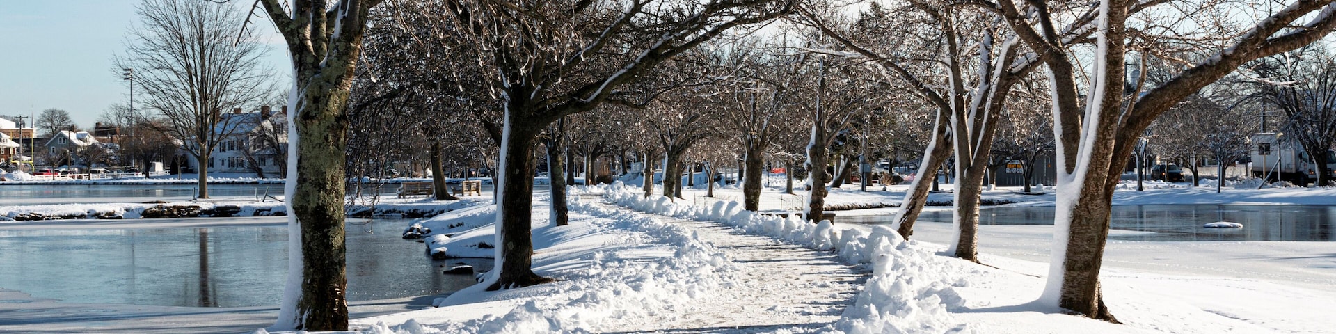 Walking path shoveled after snow storm between two lakes at Argyle Park in Babylon Village