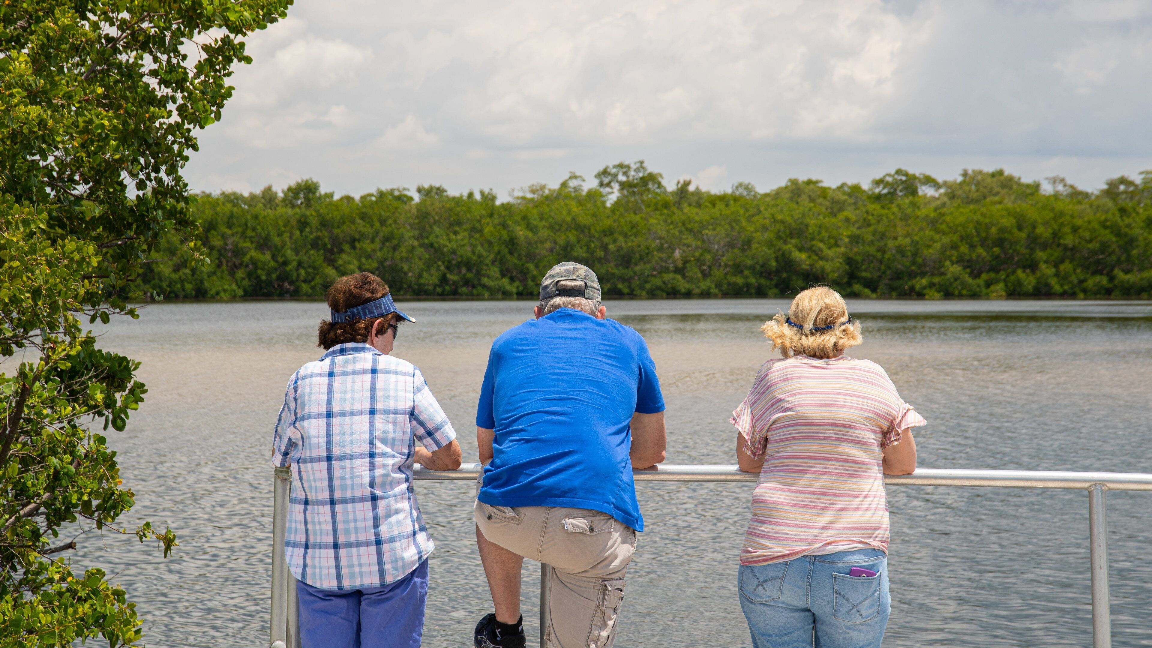 J. N. Ding Darling National Wildlife Refuge which includes a lake or waterhole as well as a small group of people