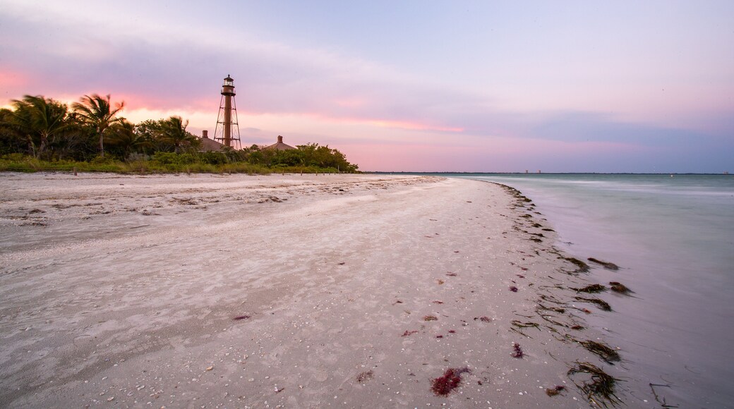 Sanibel Island Lighthouse which includes a beach, general coastal views and a sunset